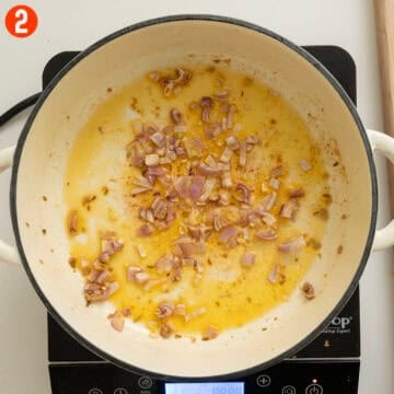 Sauteing shallots in a pan.
