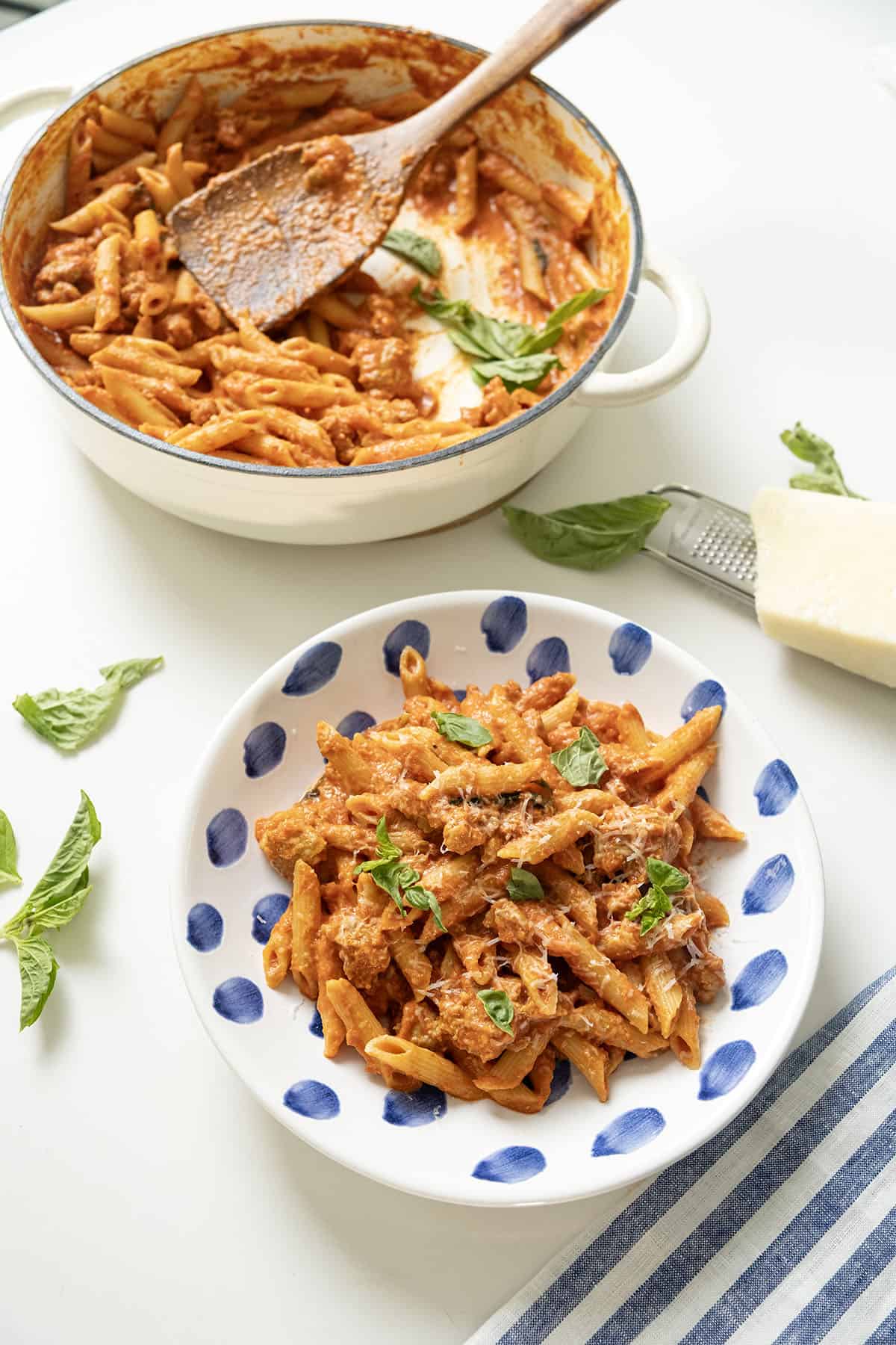 Pink sauce with penne in the pot and in a plate.