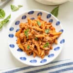 Pink sauce with penne on a plate.