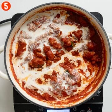 Adding heavy cream to the sauce.