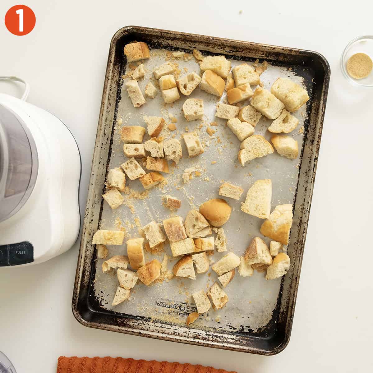 Toasting stale bread on a baking tray.
