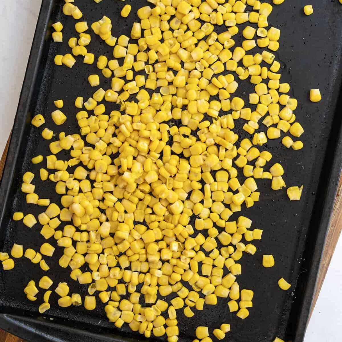 Roasting corn on a pan.