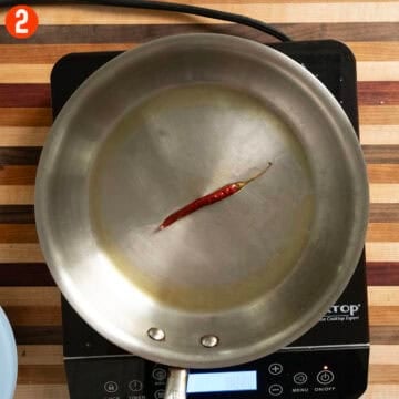 Sauteing a red pepper in olive oil.