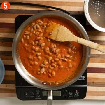 Simmering beans with marinara sauce.