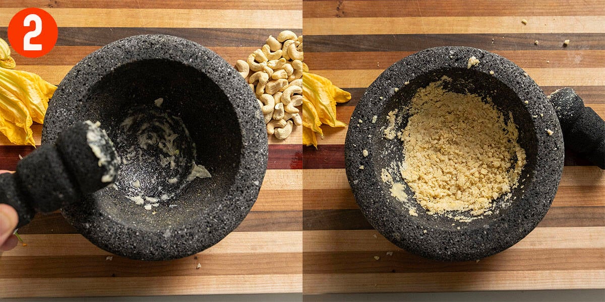 Grinding garlic and cashews in a mortar and pestle.