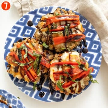 Baked stuffed mushrooms topped with roasted red peppers, basil, and balsamic glaze.