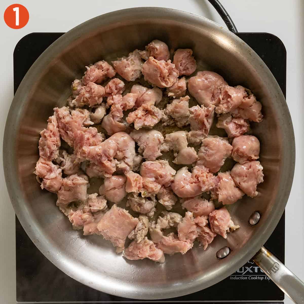 Frying sausage in a pan.