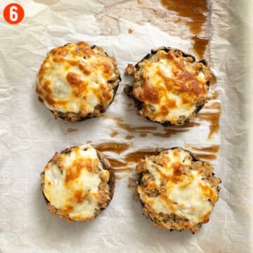 Stuffed mushrooms baked on a pan.