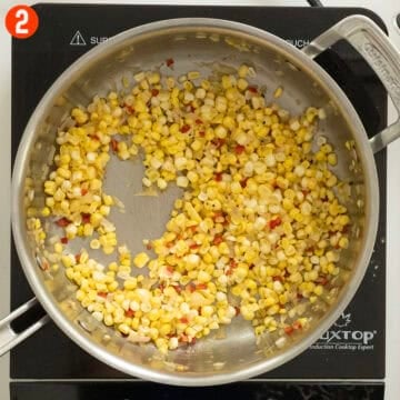 Sauteing corn with shallots and red pepper.