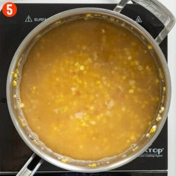 Chicken stock simmering with orzo.