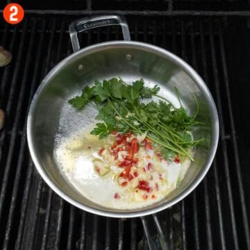 Sauteing garlic, fresno red pepper, parsley, in olive oil and butter.