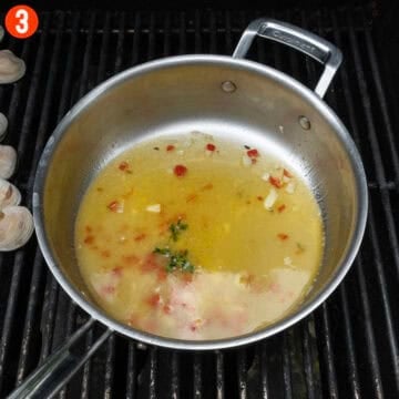 White wine sauce in a saucepan on the grill.
