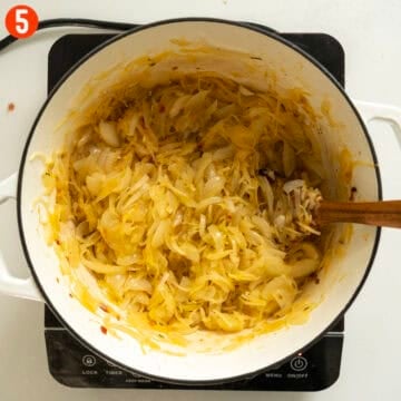 Onions and potatoes softened and caramelized in a dutch oven.