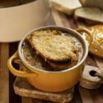 Licurdia soup in a bowl topped with bread and melted cheese.