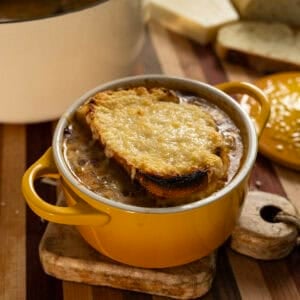 Licurdia soup in a bowl topped with bread and melted cheese.