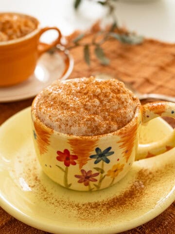 Italian rice pudding served in a cup, sprinkled with cinnamon.