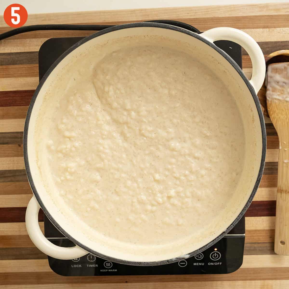 Thickened rice pudding in saucepan.