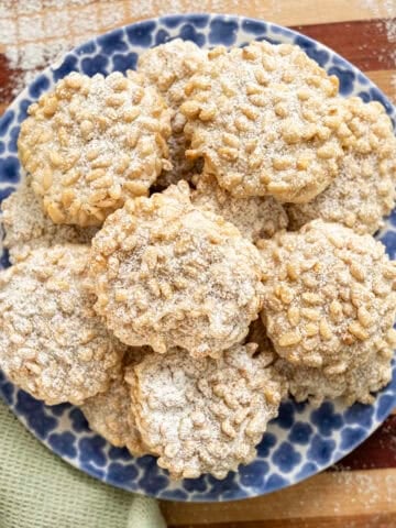 Pignoli cookies on a plate.