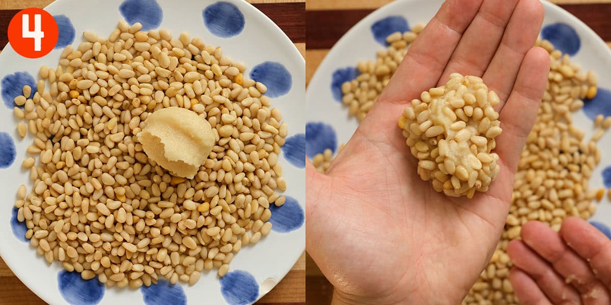 Hand rolling pignoli cookies in pine nuts