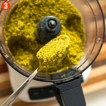 Grinding pistachios in a food processor.