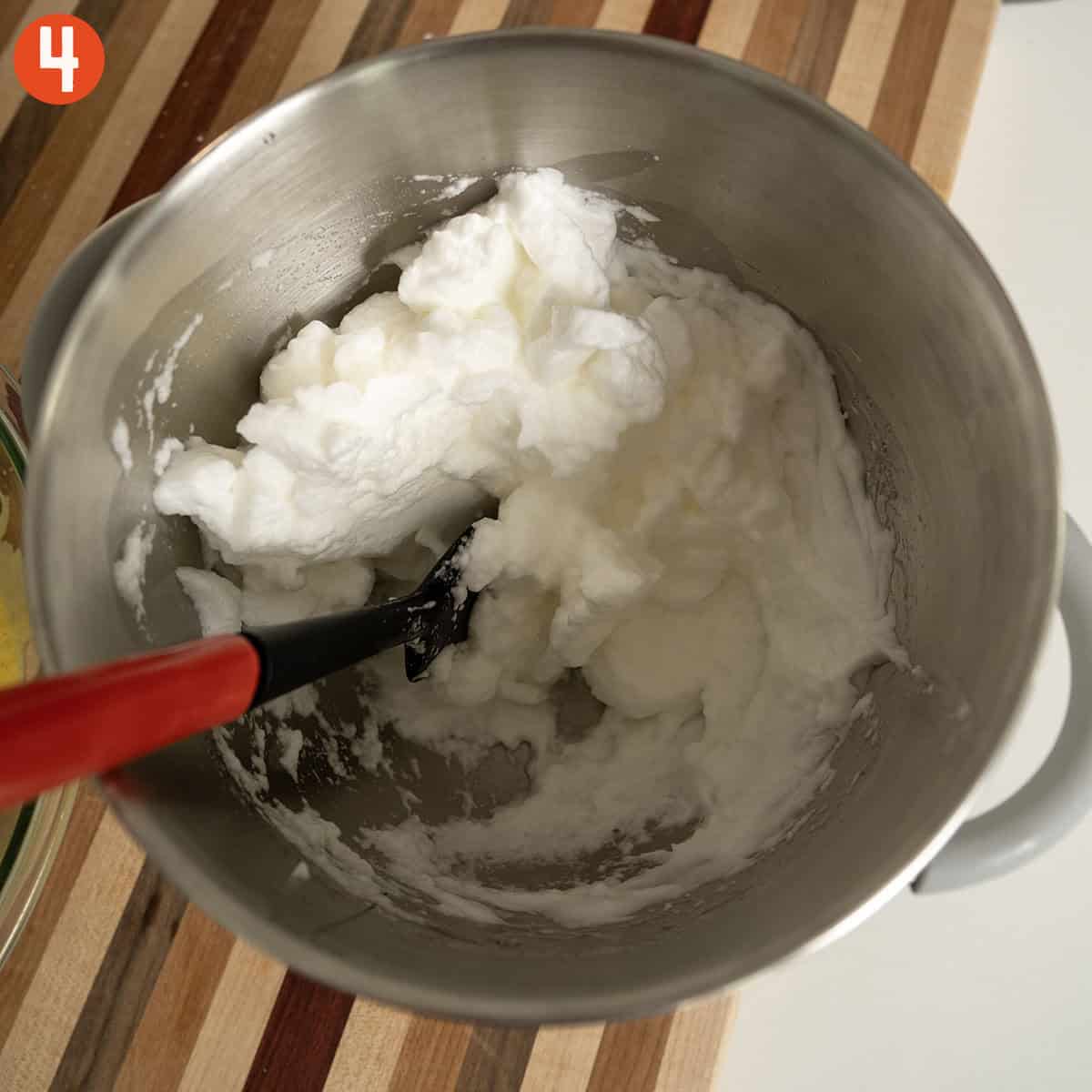 Whisking egg whites to stiff peaks.