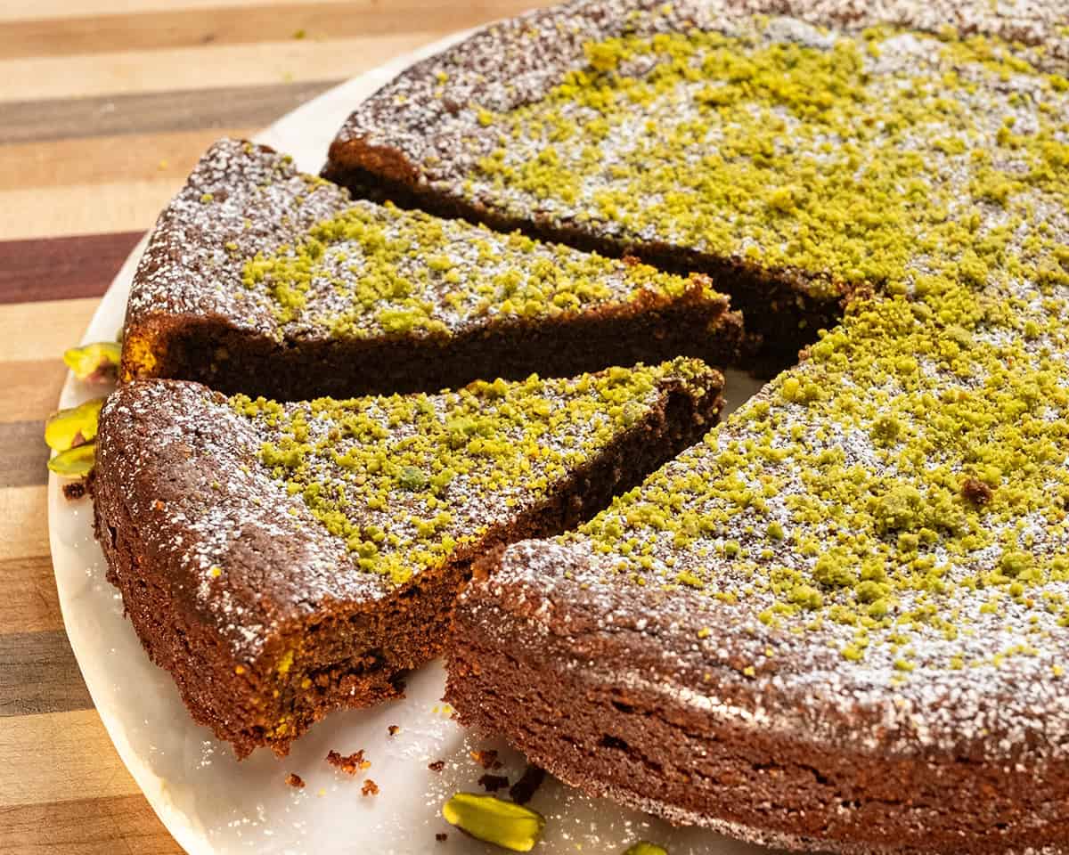 Italian Torta caprese topped with ground pistachios and powdered sugar.