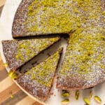 Italian Torta caprese topped with ground pistachios and powdered sugar.