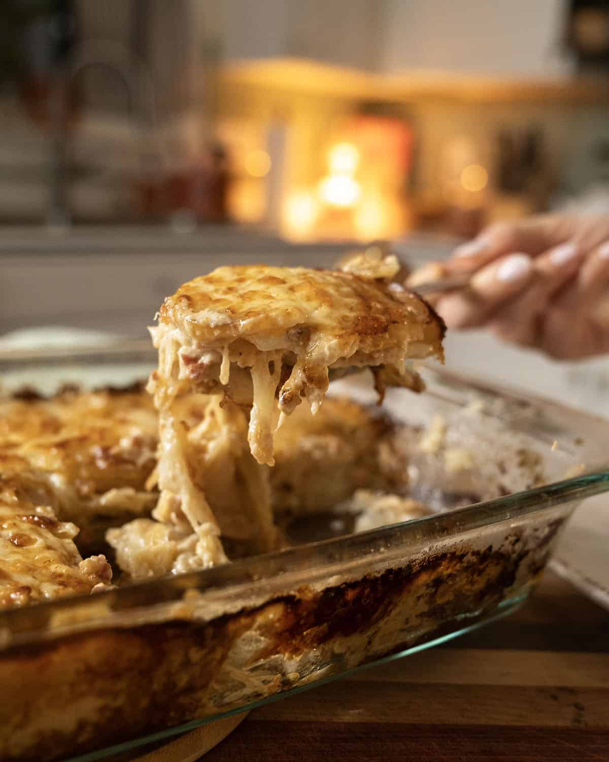Spooning out the fennel and potato au gratin.