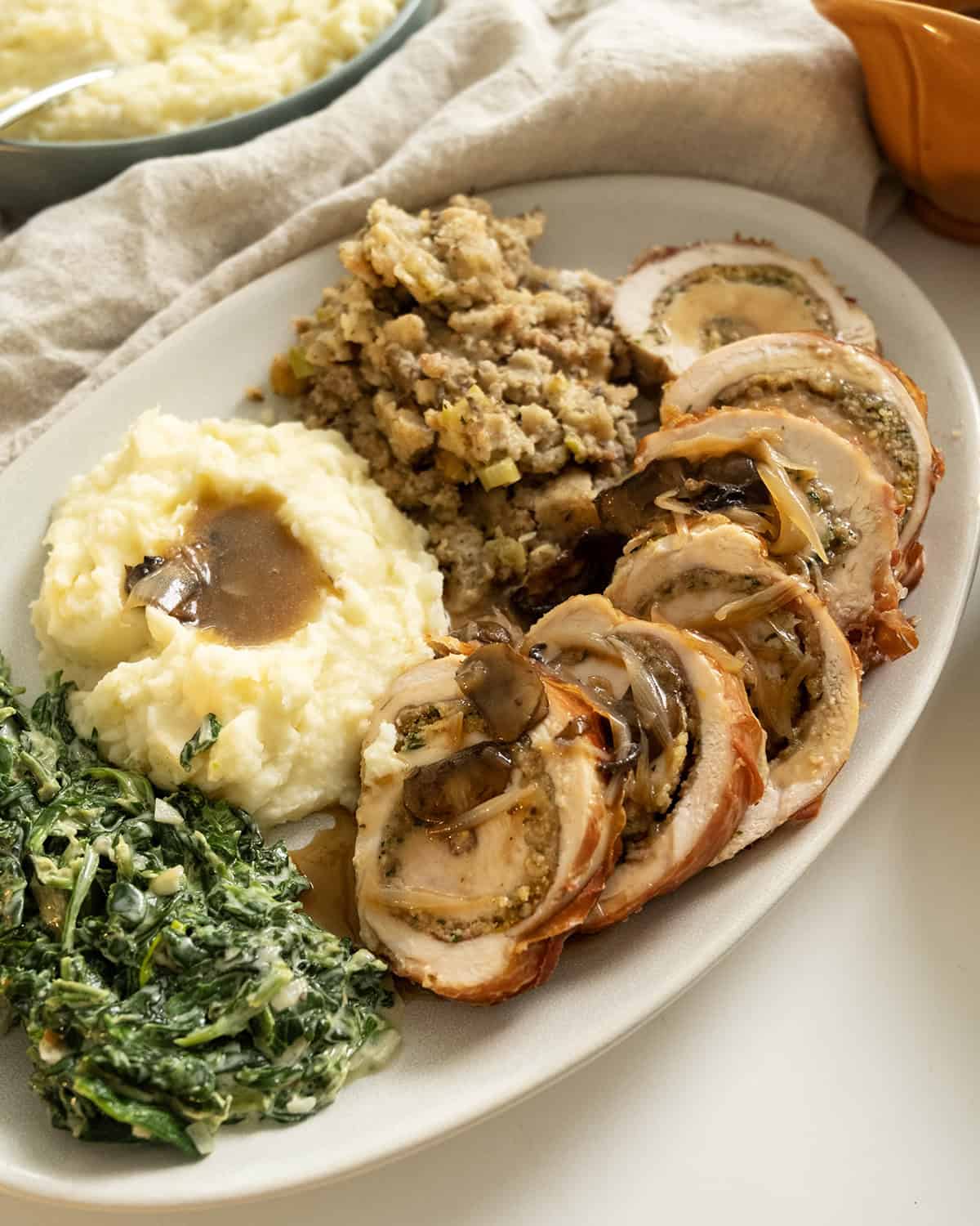 Gravy poured over turkey and mashed potatoes.