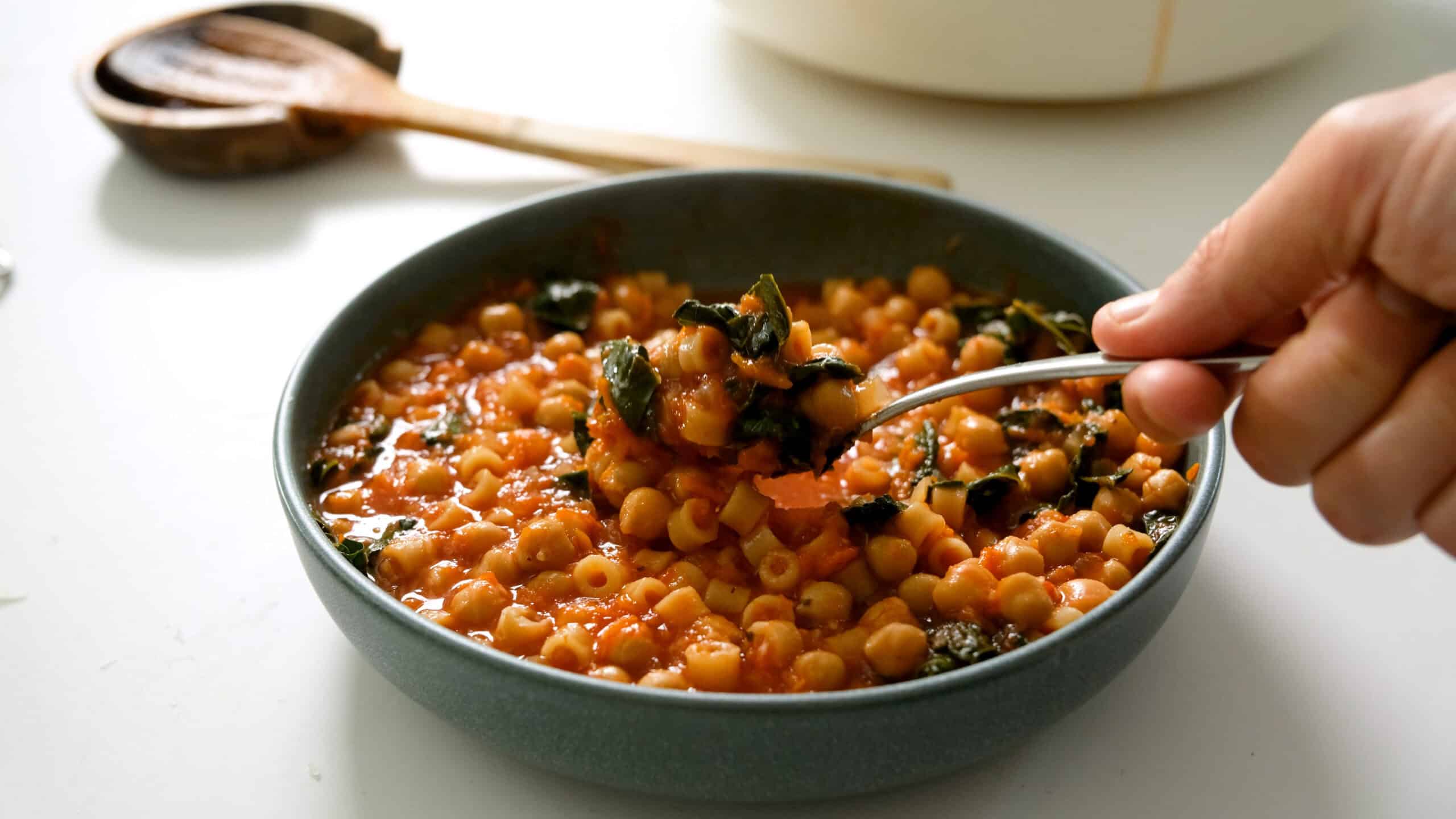 Thick stew-like texture pasta e ceci on a spoon.