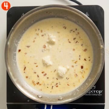Cream, parmigiano, and mascarpone combined in pan.