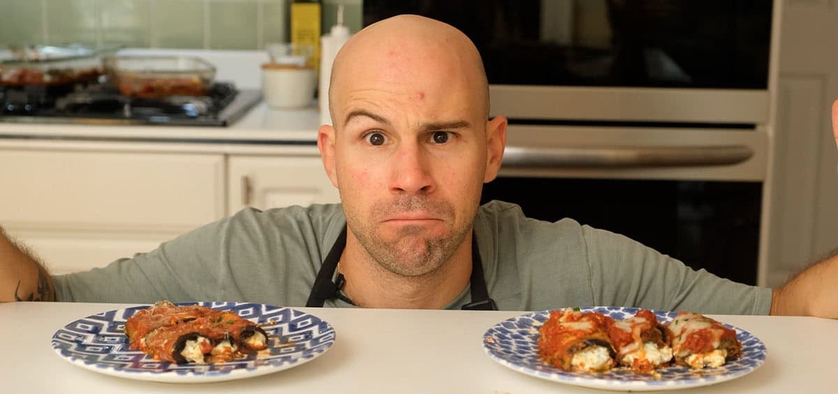The author, Vinny, pointing at a plate of breaded and unbreaded eggplant rollatini.