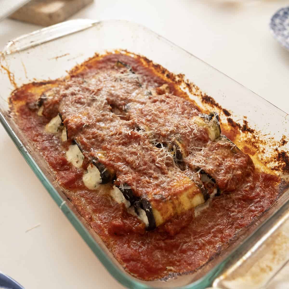 Baked unbreaded eggplant rollatini in a baking tray.