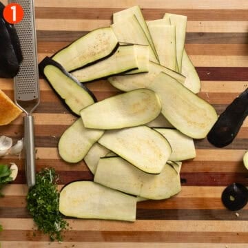 Sliced eggplant on a cutting board.